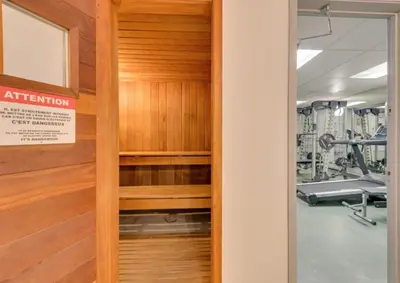 a door leading to a gym with a treadmill at Magog Waterfront Condo in Magog-Orford