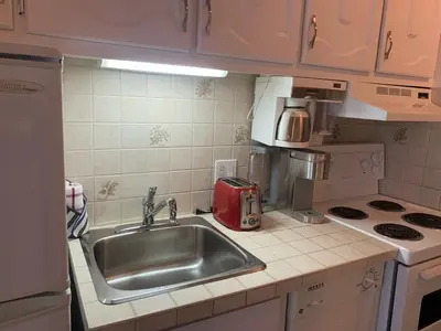 a kitchen with a sink and a toaster on the counter at Magog Waterfront Condo in Magog-Orford