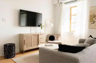 a living room with a couch and a tv at Maison Rasco by Luxury In Transit in Montréal