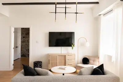 a living room with a couch and a table at Maison Rasco by Luxury In Transit in Montréal