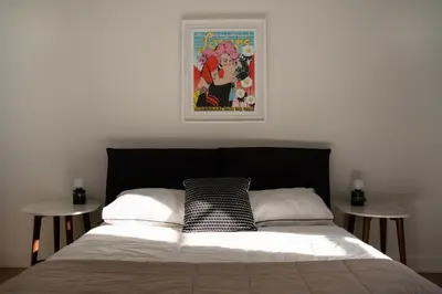 a bedroom with a bed with two tables at Maison Rasco by Luxury In Transit in Montréal