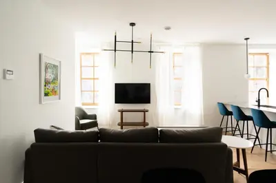 a living room with a couch and a table at Maison Rasco by Luxury In Transit in Montréal