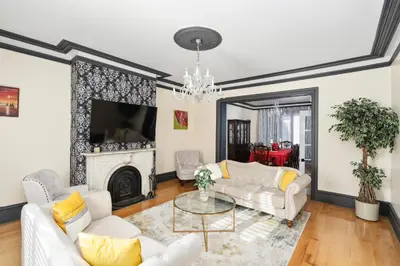 a living room with white furniture and a fireplace at Centennial 6-Bedroom Waterfront Palace Sleeps 14 in Montréal