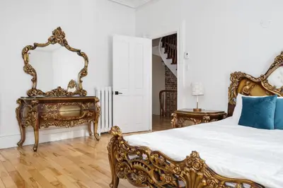 a bedroom with a large bed and a mirror at Centennial 6-Bedroom Waterfront Palace Sleeps 14 in Montréal
