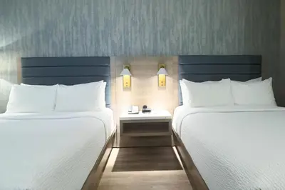 two beds sitting next to each other in a room at Radisson Hotel Montreal Airport in Saint-Laurent