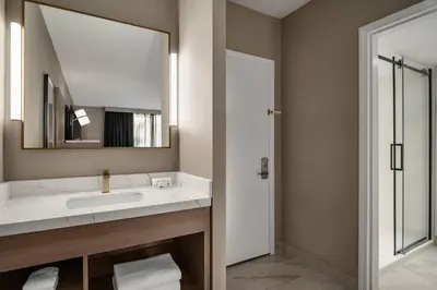 a bathroom with a sink and a mirror at Radisson Hotel Montreal Airport in Saint-Laurent