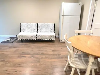 a living room with a table and a couch at Cozy spacious Apt In Laval, Greater Montreal in Laval