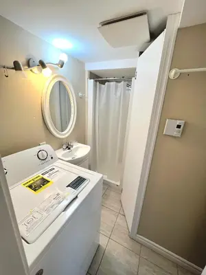 a bathroom with a sink and a mirror at Cozy spacious Apt In Laval, Greater Montreal in Laval