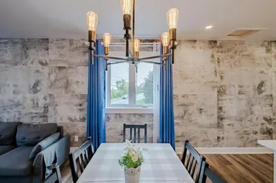 a dining room with a table and a couch at Nice River & Mountain View+4 Beds+Free parking in McMasterville
