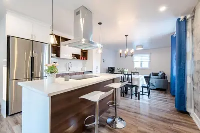 a kitchen and living room with a large counter and chairs at Nice River & Mountain View+4 Beds+Free parking in McMasterville