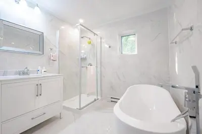 a white bathroom with a shower and a toilet at Nice River & Mountain View+4 Beds+Free parking in McMasterville