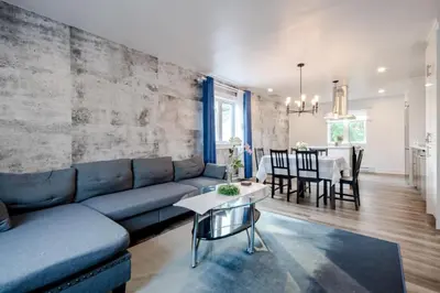 a living room with a blue couch and a table at Nice River & Mountain View+4 Beds+Free parking in McMasterville