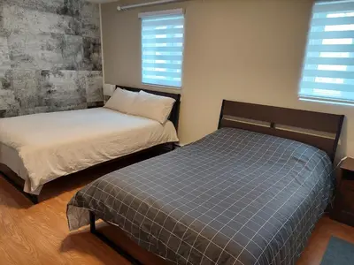 a bedroom with two beds and two windows at Nice River & Mountain View+4 Beds+Free parking in McMasterville