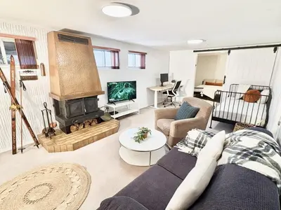 a living room with a couch and a fireplace at Montreal - Laval Haven - Entire Rental Unit in Laval