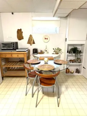 a kitchen with a table and chairs in a room at Montreal - Laval Haven - Entire Rental Unit in Laval