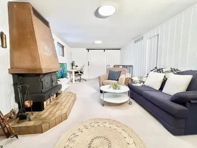 a living room with a blue couch and a fireplace at Montreal - Laval Haven - Entire Rental Unit in Laval