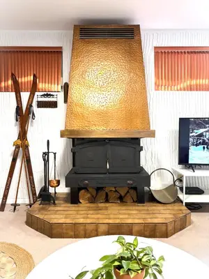 a living room with a fireplace with a lamp at Montreal - Laval Haven - Entire Rental Unit in Laval