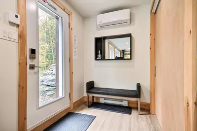 a black bench in a room with a window at Sutton Wellness cabin #267 Rez-de-chaussée in Sutton