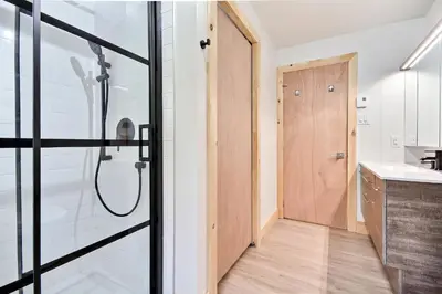 a bathroom with a shower and a sink at Sutton Wellness cabin #267 Rez-de-chaussée in Sutton
