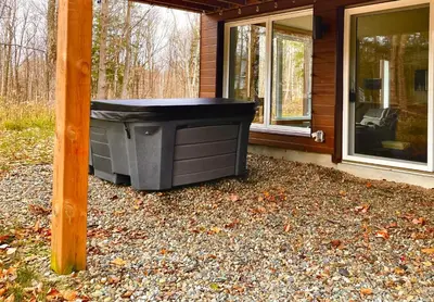 a trash can sitting outside of a house at Sutton Wellness cabin #267 Rez-de-chaussée in Sutton