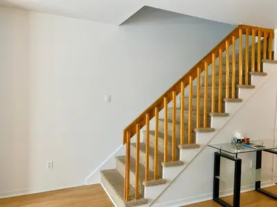 a staircase in a home with a glass table at Condo Club Azur Plage Memphremagog in Magog-Orford