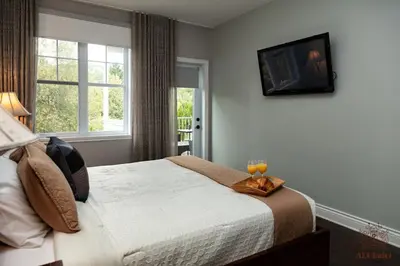a bedroom with a bed with a tray of oranges on it at Le Champlain 101- Condo avec Piscine in Bromont