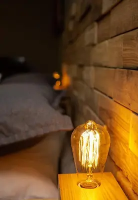 a lamp sitting on a table next to a wall at Condo Hotel Au pied du Mont Orford in Orford