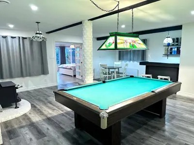 a living room with a pool table in it at Newly Renovated villa with magnificent views in Coaticook
