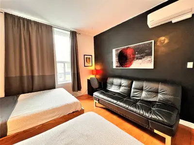 a bedroom with a bed and a couch at ReUnion in Montréal