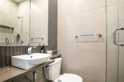 a bathroom with a toilet and a sink at hotel le coach in Montréal