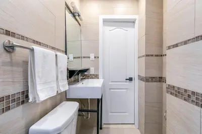 a bathroom with a sink and a toilet and a mirror at hotel le coach in Montréal