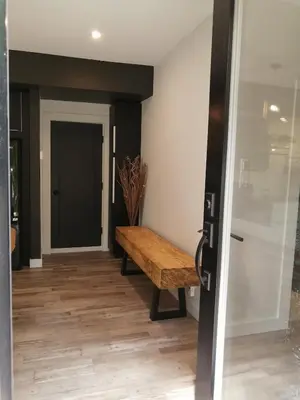a hallway with a wooden bench next to a door at loft in the mountains, near Bromont in Shefford