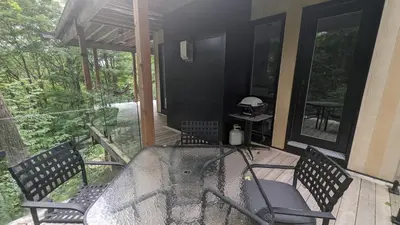 a screened in porch with a table and chairs at loft in the mountains, near Bromont in Shefford