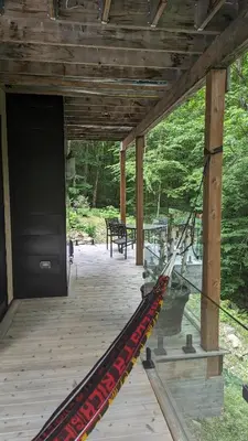 a wooden porch with a hammock on it at loft in the mountains, near Bromont in Shefford
