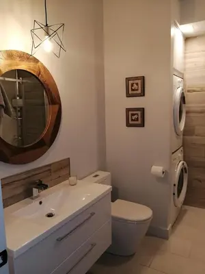 a bathroom with a sink and a toilet and a mirror at loft in the mountains, near Bromont in Shefford