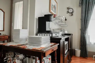 a kitchen with a pile of dishes on a table at Chez l'Doc in Saint-Prosper