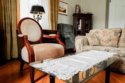 a living room with a couch and a table and chairs at Chez l'Doc in Saint-Prosper