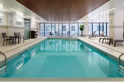 a swimming pool with blue water in a building at Courtyard Montreal Midtown in Montréal