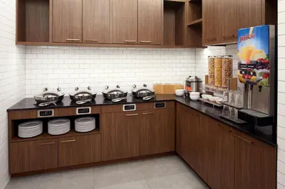 a kitchen with wooden cabinets and pots and pans at Residence Inn Montreal Midtown in Montréal
