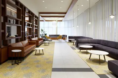 a waiting area with couches and tables in a lobby at Residence Inn Montreal Midtown in Montréal