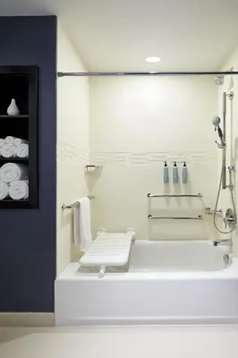 a white bathroom with a tub and a sink at Residence Inn Montreal Midtown in Montréal