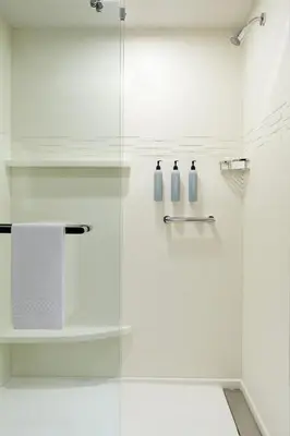 a bathroom with a shower with a glass door at Residence Inn Montreal Midtown in Montréal