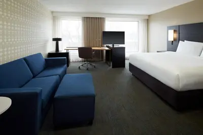 a hotel room with a bed and a couch at Residence Inn Montreal Midtown in Montréal