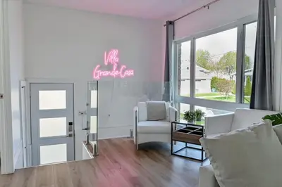 a living room with a sign that reads the forever club at Villa luxueuse avec vue sur le fleuve Villa GrandeCasa in Trois-Rivières