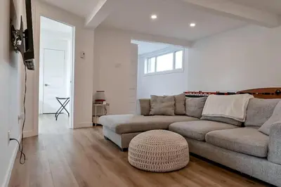 a living room with a couch and a table at Villa luxueuse avec vue sur le fleuve Villa GrandeCasa in Trois-Rivières