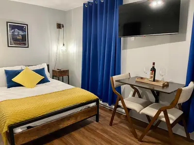 a bedroom with a bed and a table and a tv at Grand Central Hotel Richmond in Richmond