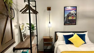 a bedroom with a bed and a poster on the wall at Grand Central Hotel Richmond in Richmond