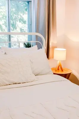 a bedroom with a white bed and a window at AFRICA - SelfCheckIn - Plateau - St-Laurent in Montréal
