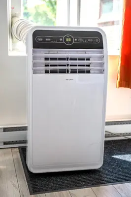 a white oven sitting on a floor next to a window at AFRICA - SelfCheckIn - Plateau - St-Laurent in Montréal