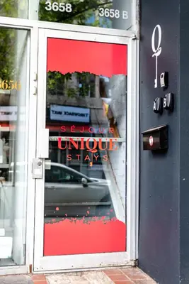 a store front door with a sign in the window at AFRICA - SelfCheckIn - Plateau - St-Laurent in Montréal